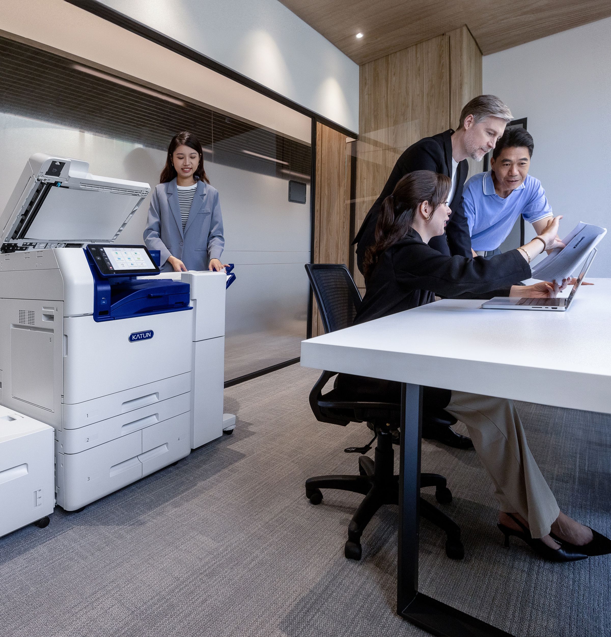 People working in an office with an Arivia Multifunction Printer (MFP)