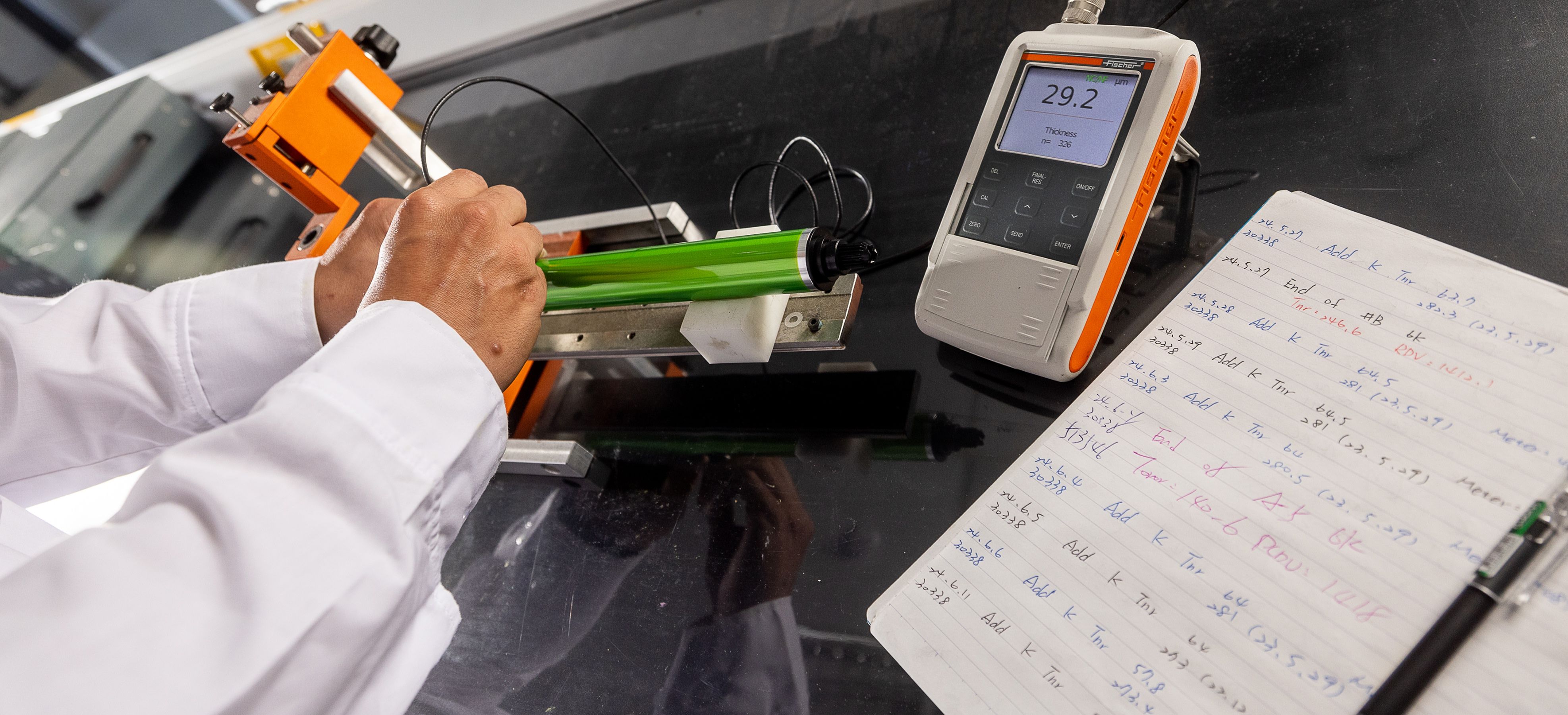 Katun Innovation Hub Technician Running Tests and Taking Notes